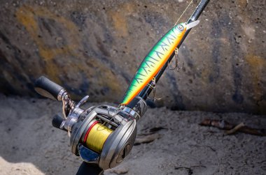 A photo of a rigged up baitcasting reel ready to catch a giant pike. Close-up clipart