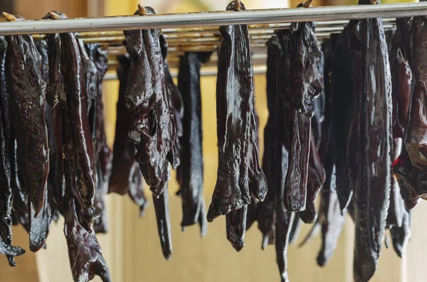 Homemade dried pet treats. Chunks of beef liver are hung for the dryer. Healthy chewable treats for dogs. Selective focus.