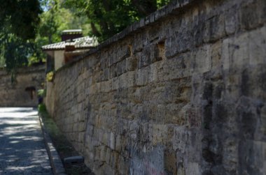 Kenarlarında taş duvarlar olan boş bir şehir caddesi. İniş, granit kaldırım taşlarıyla döşenmiş. Güney şehrinde yaz güneşli bir gün. Hiç kimse olmadan.