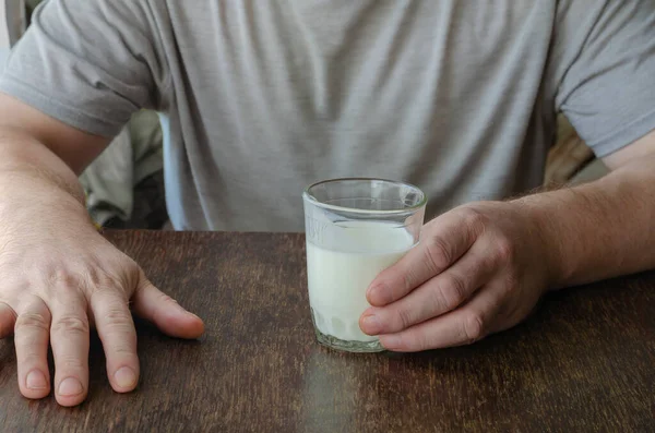 Man Sits Table Half Empty Glass Kefir Hand Holds Fermented — Stock Photo, Image