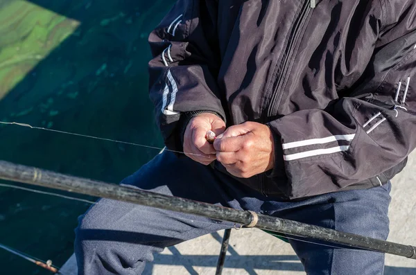 Year Old Man Removes Small Fish Hook Close Wrinkled Hands — Stock Photo, Image