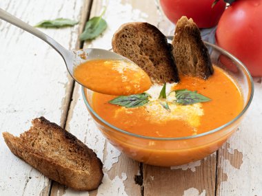 Ahşap tahta üzerinde domates çorbası ile kase