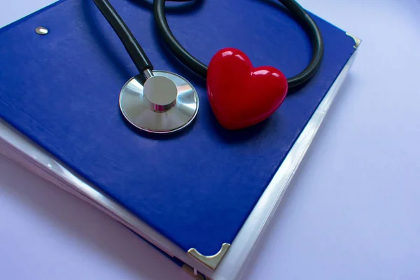 Stethoscope and red heart. Concept of heart disease.