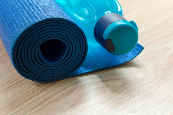 Yoga mat and a bottle of water, the concept of training and recreation. sports and health