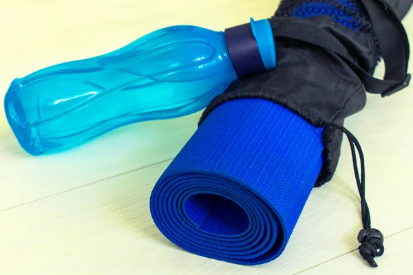 Yoga mat and a bottle of water, the concept of training and recreation. sports and health