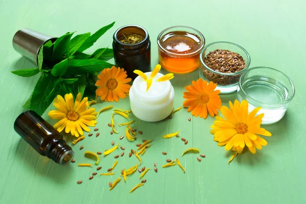 Production of natural cosmetics. Medicinal flowers of calendula, chamomile, mint and herbal tincture, aroma oil, honey. Medicinal herbs. Inhabited background Organic cosmetology.