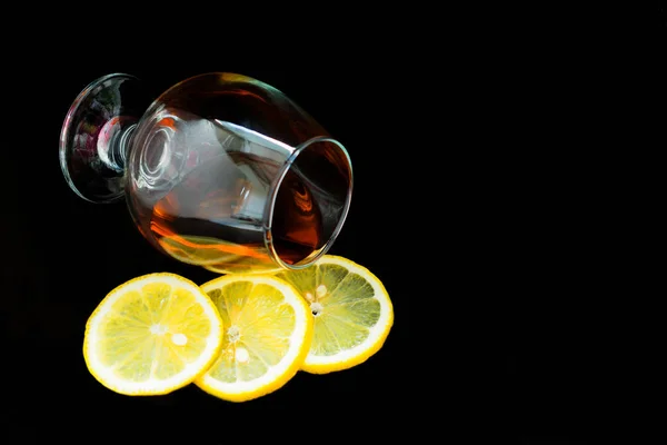 Glass Cognac Lemon Slices Isolated Black Background Copy Space — Stock Photo, Image