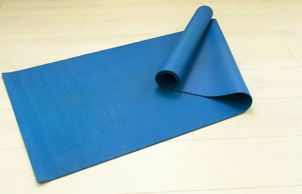 Blue yoga mat view from the top. The concept of yoga.