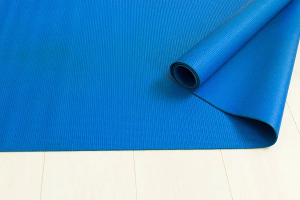 Blue yoga mat view from the top. The concept of yoga.