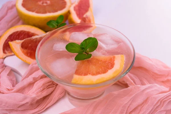 Grapefruit cocktail with ice and mint on. Top view.