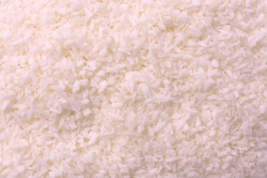 Parçalanmış hindistan cevizi taneleri soyut doku arkaplanı. Hindistan cevizi parçacıklarının arkaplanı.