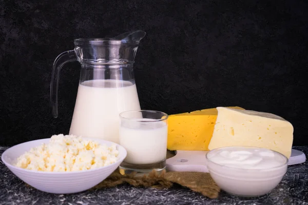 Set of dairy products on a black background. Organic food. Copy space.