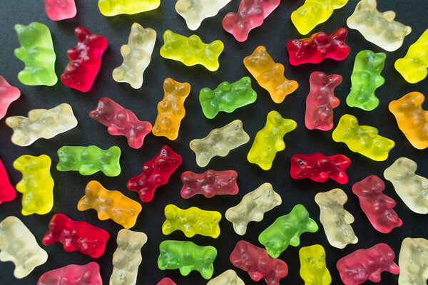 Jelly bears on a black background. Background from jelly bears.
