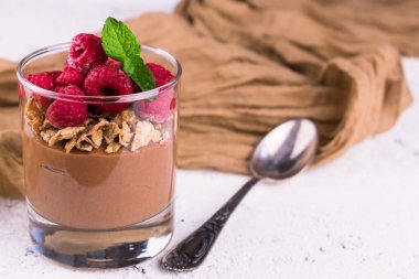 Ahududulu çikolatalı puding ve beyaz bir tabakta nane şekeri. Boşluğu kopyala..