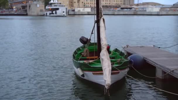 Vacker segling liten båt vid piren gungar i vågorna — Stockvideo