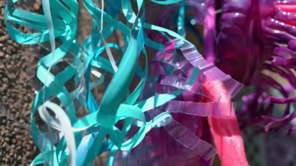 Long multi-colored ropes made from used plastic bottles, in different colors — Stock Video