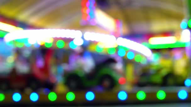 Childrens carousel at night with blinking lights. blurry video. — Stock Video