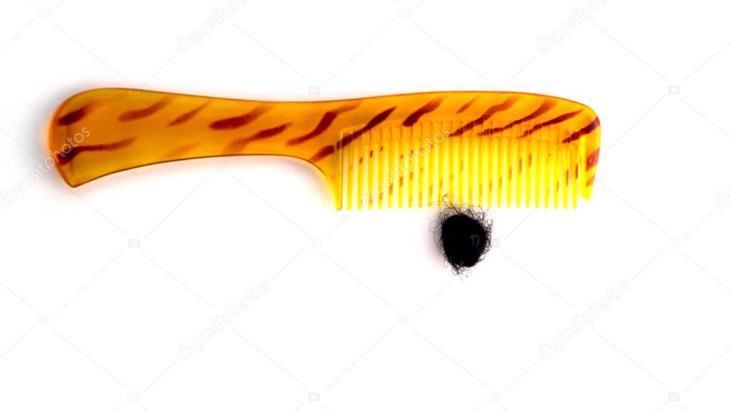 Golden comb with stripes and hair fall as well as dandruff. Phots demostration of hair loss while combing.