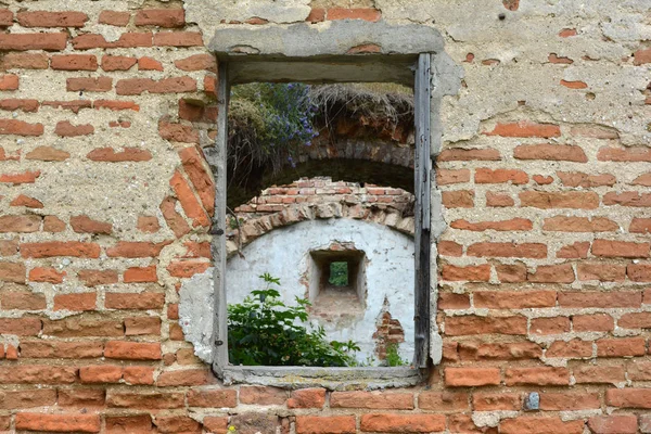 Small arched window in window in ruins of ancient castle. Belarus.