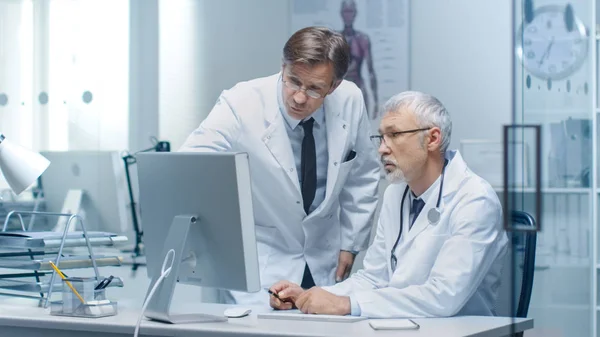 Senior Läkare Och Hans Assistent Diskutera Patientens Log Persondator — Stockfoto