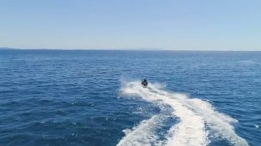 Bir çift bir kayak Jet dalgaları aracılığıyla sürüş üzerinde çekim sonrasında hava. Hava Sunny ve okyanus mavi.