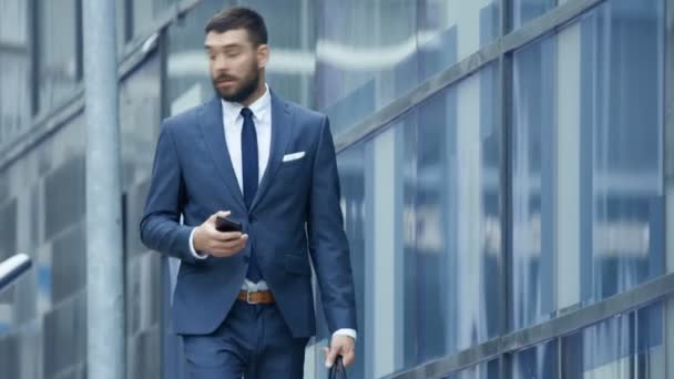 Concerned Business Man Hurry Uses Smartphone While Walking Business District — Stock Video