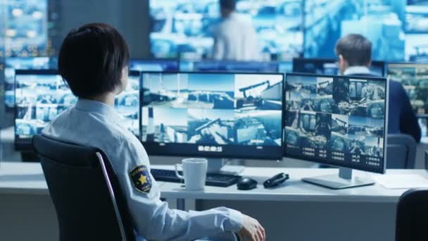 Security Control Room Officer Monitors Multiple Screens Suspicious Activities Reports — Stock Video