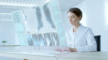 Yakın bir gelecekte güzel erkek doktor eserlerinden şeffaf bilgisayarda görüntülemek. Hastanın tıbbi geçmiş, x-ışını ve Test sonuçları ile ekran gösterir.