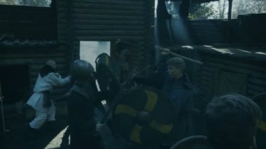 Büyük ölçekli ortaçağ savaş Reenactment. Viking ve Slav savaşçılar mücadele ile kılıç, balta ve kalkanlar ahşap kalenin bahçesinde.