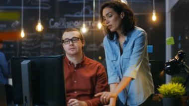 Erkek ofis çalışanı onun resepsiyon ve kadın arkadaşı ile görüşmelerde, o puan onun monitöre oturur. Arka plan yaratıcı ofiste.