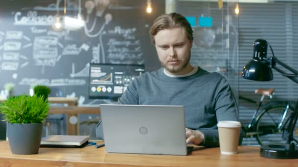 Handsome Young Office Employee Thinks Problem Solution While Typing Laptop — Vídeo de Stock