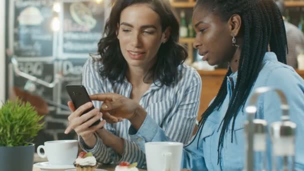 Две Великолепные Подруги Веселятся Сидя Кафе Одна Снимает Мобильный Телефон — стоковое видео