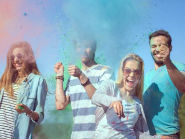 Çok etnik grup genç insanlar atmak renkli toz birbirimize Holi Festivali kutlama. Büyük açık bu günde deniz kenarında eğleniyorlar.