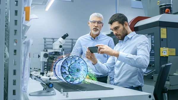 Two Engineers Works Mobile Phone Using Augmented Reality Holographic Projection — Stock Photo, Image