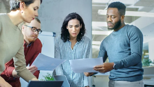 Diverse Group of Young Professionals Surround Conference Table and Collectively Try to Solve Problem.