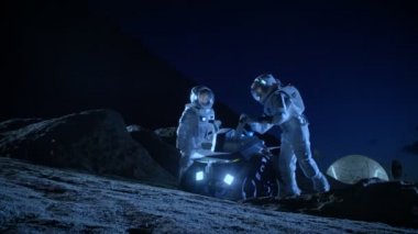 Yabancı bir gezegende uzay elbiseli iki astronot uzay Rover yüzey Araştırma görev için hazır olun. Uzay kolonizasyon hakkında futuristik konsepti.