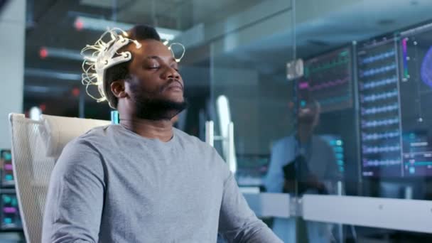 Άνθρωπος Φορώντας Brainwave Σάρωση Ακουστικά Κάθεται Μια Καρέκλα Ενώ Επιστήμονας — Αρχείο Βίντεο