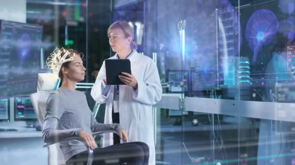 Woman Wearing Brainwave Scanning Headset Sits Chair While Scientist Adjusts — Stock Video