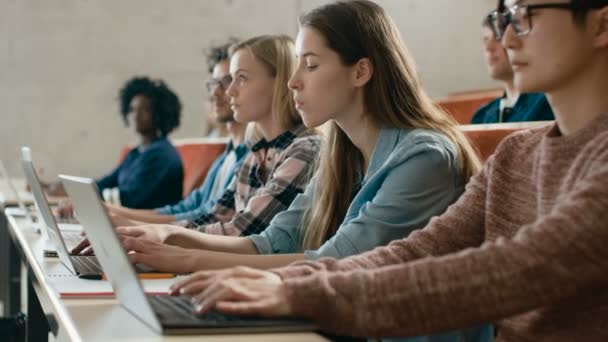 Row Multi Ethnic Students Working Laptops While Listening Lecture Modern — Vídeo de stock