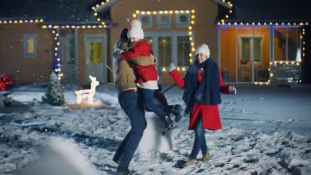 Happy Young Family Portrait Falling Snow Father Embraces Wife Holds — Video