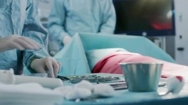 Ameliyat Sırasında AmeliyatHanede Aletlerle Ameliyathanede Yakın Çekim, Cerrahlara Yardımcı Aletler Dağıtılır. Ameliyat devam ediyor. Cerrahi Yapan Profesyonel Tıp Doktorları.