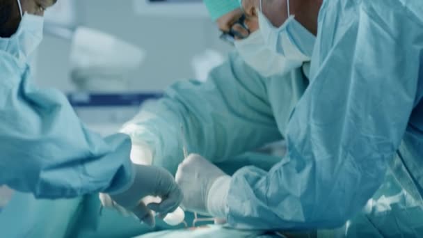 Diverse Team of Professional Surgeons Performing Invasive Surgery on a Patient in the Hospital Operating Room. Surgeons Use  and other Instruments. — Stock Video