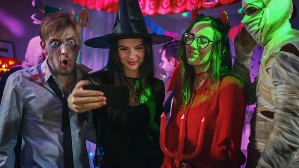 Fête costumée d'Halloween : Zombie mort cérébrale, Dracula assoiffée de sang, Maman bandée Belle sorcière et séduisante Elle diable posant pour la vidéo de groupe Selfie pris avec Smartphone. Monstres amusez-vous . — Photo