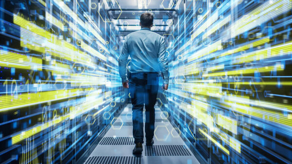 Shot of a Young It Specialist Walking through Corridor in Working Data Center Full of Rack Servers and Supercomputers. Conceptual Visualisation of High Speed Internet Connection with Yellow Lines.