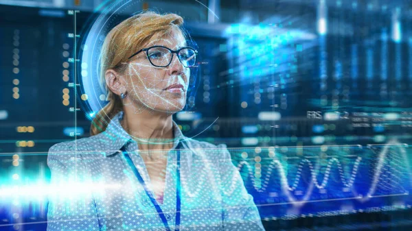 Female IT Engineer Identified by Biometric Facial Recognition Scanning Process in Data Center Server Room. Futuristic Concept: Projector Identifies Individual by Illuminating Face by Lines.