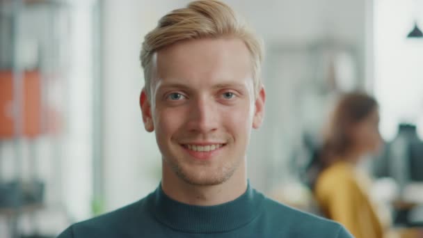 Portrait of Handsome Professional Caucasian Man Looking at the Camera and Smiling Charmingly. Successful Blonde Man Working in Bright Diverse Office — Stock Video