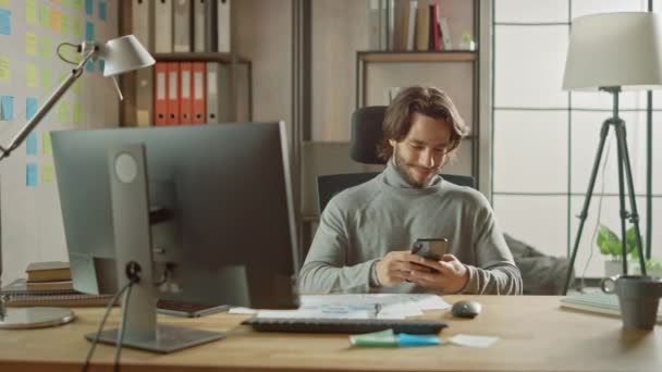 Handsome Long Haired Entrepreneur Sitting At His Desk In The