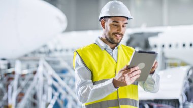 Portre uçak bakım mekanik Emanet Tablet bilgisayar kullanarak yelek