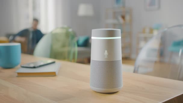 Man Turns On Smart Speaker that Activates Artificial Intelligence Assistant. — Stock Video