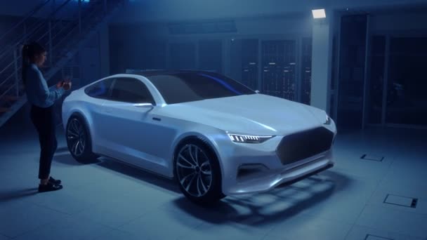 Female Automotive Engineer Uses Digital Tablet with Augmented Reality for Car Design Improvement. 3D Graphics Visualization Shows Fully Developed Vehicle Prototype With Turned On Headslights — Stock Video